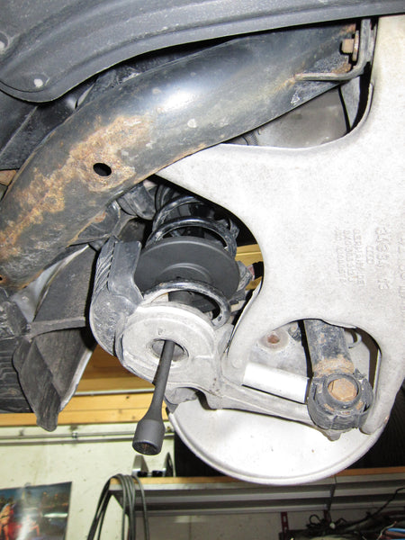 Telescopic internal spring compressor