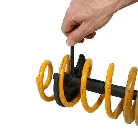 Telescopic internal spring compressor